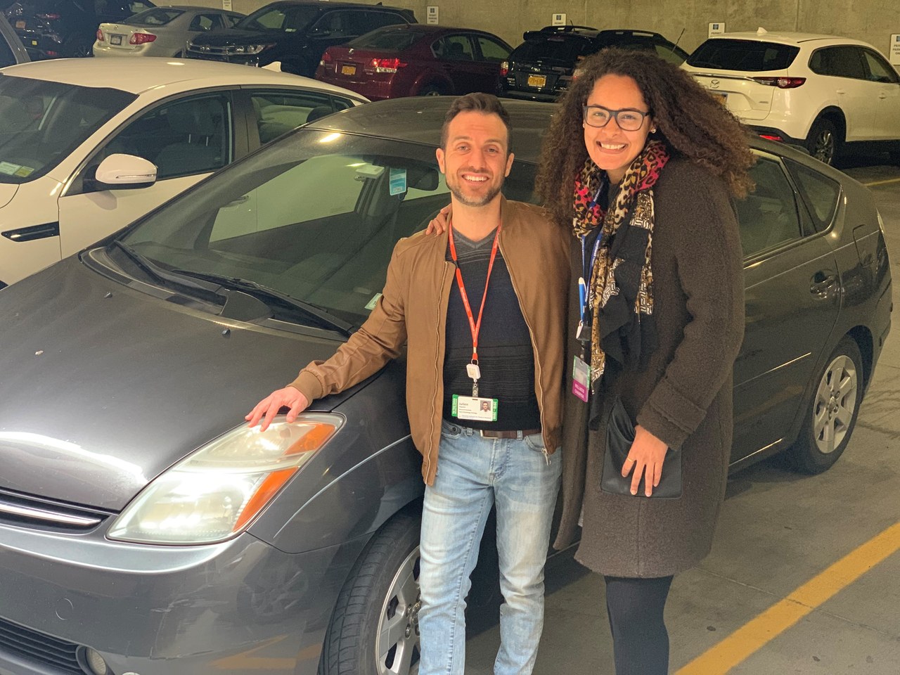 Naomi and Julien standing by car